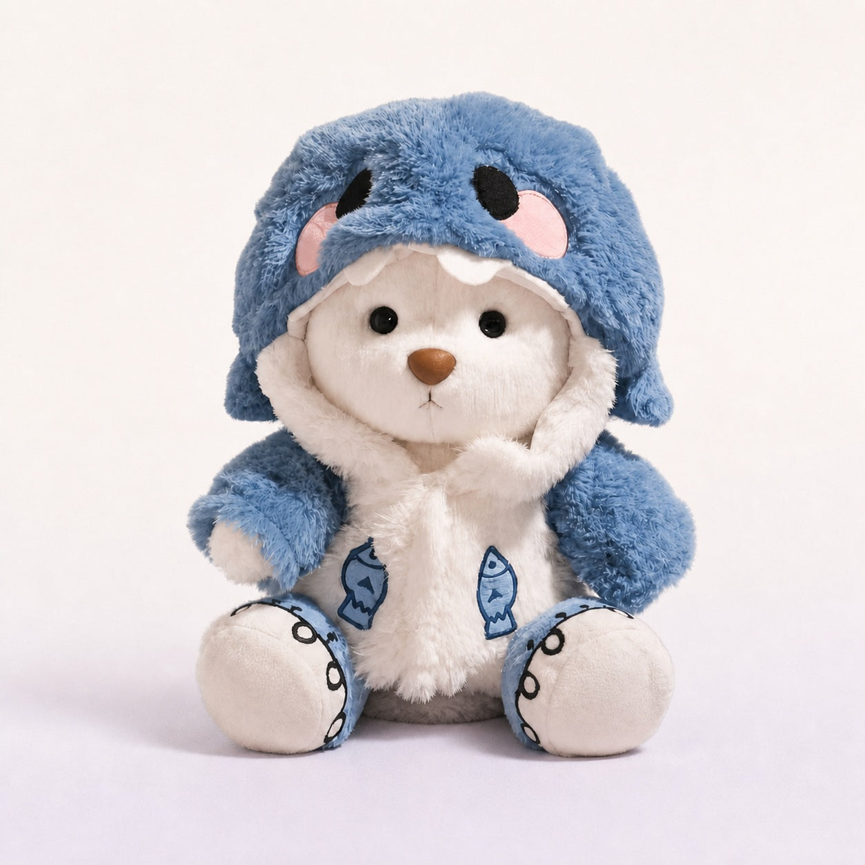 Finn the Shark Bear, a white bear plushie in a blue shark costume
